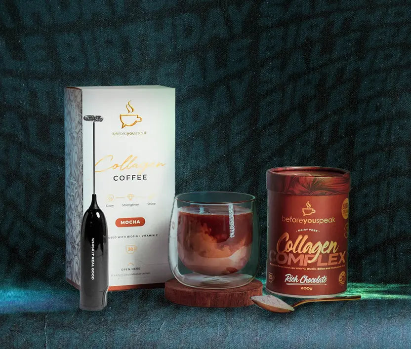A styled product display featuring a box of Collagen Coffee (Mocha flavor), a black milk frother wand, a glass of collagen-infused coffee, and a canister of Collagen Complex (Rich Chocolate flavor) on a dark textured background.