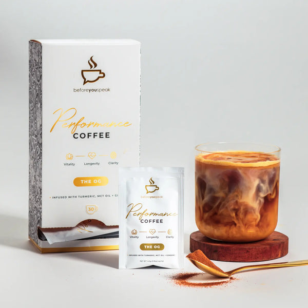 Packaging and sachet of Performance Coffee with a prepared cup of coffee, emphasizing the product's energy-boosting ingredients like Turmeric, MCT Oil & Siberian Ginseng.